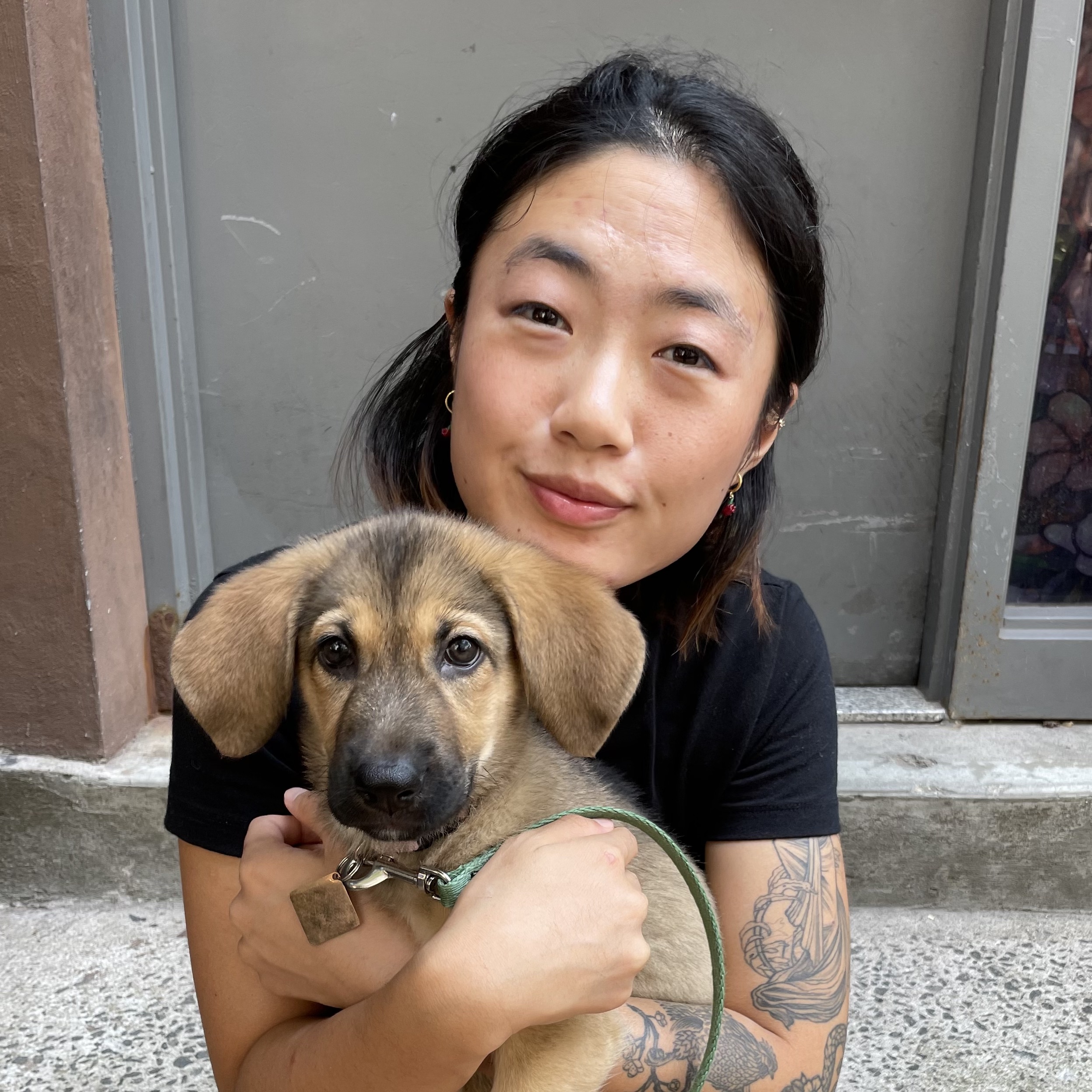 photo of yuxi holding a puppy with big ears